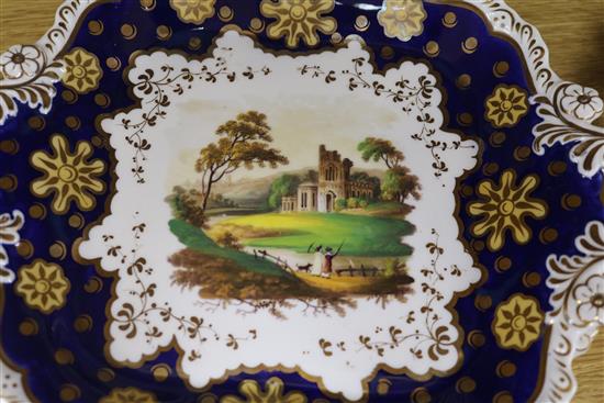 A Staffordshire dessert service, decorated in cobalt blue and gilt and painted topographical scenes